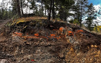 Sampling Outcrop at North Drill Pad. Note the thin overburden cover.