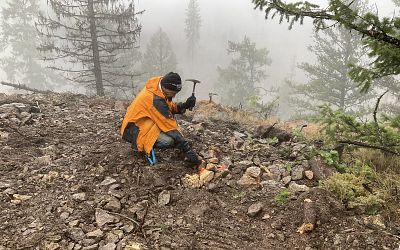 Sampling new exposure uncovered during drill pad preparation.